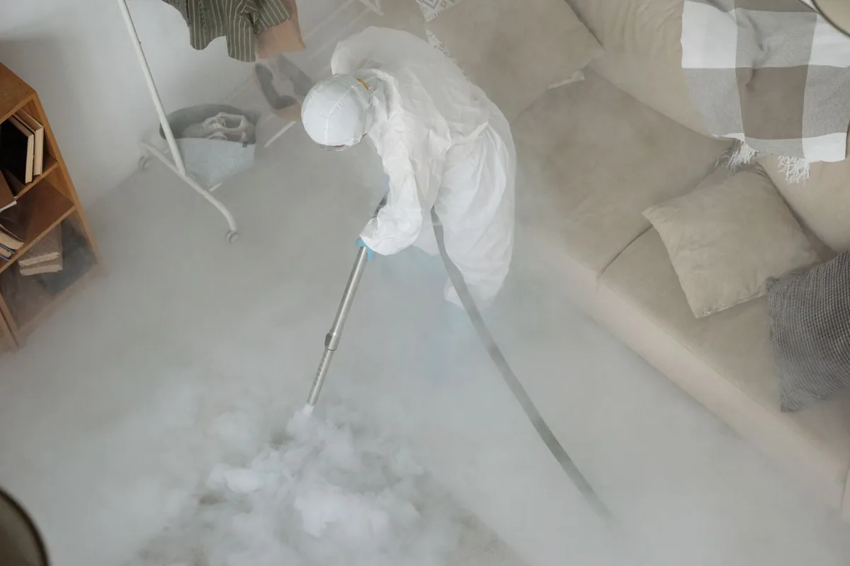 Biohazard cleanup technician in protective equipment, Highland, KS